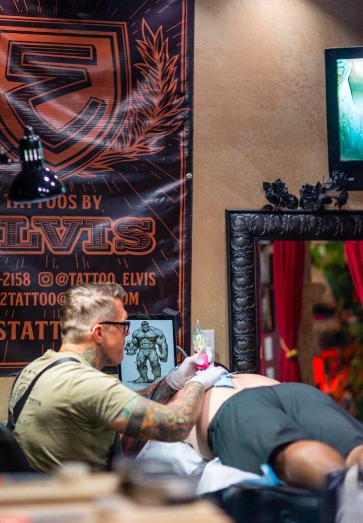 Jason “Elvis” Martin tattooing a client in his Nashville studio, specializing in black and grey and neotraditional tattoo styles