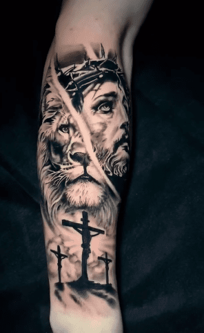 Black and grey realism tattoo by Jason “Elvis” Martin, depicting Jesus crowned with thorns alongside a lion and three crosses.