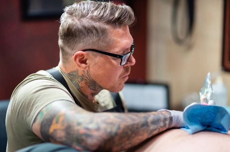 Portrait of Jason “Elvis” Martin, founder of Elvis Tattoo Shop in Nashville, known for custom black and grey realism tattoos